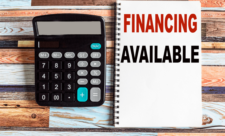A calculator next to a notebook that says "Financing Available"