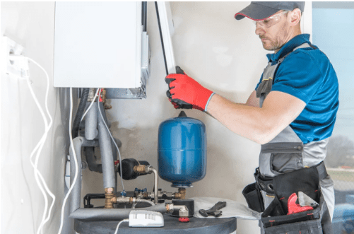 technician shown performing a water heater repair service job