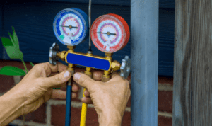 person reading ac repair gauge